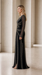 Model wearing black beaded evening gown side view