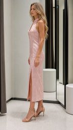 Side profile view of pink midi dress with high slit