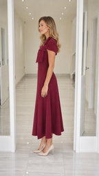 Side profile view of burgundy midi dress