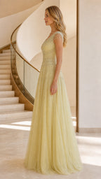 Side profile of yellow beaded tulle evening gown