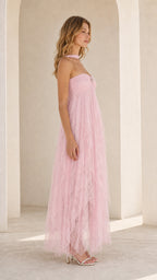 Model wearing pink strapless tulle maxi dress side profile view