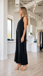 Model wearing black fringe pant set, side profile view