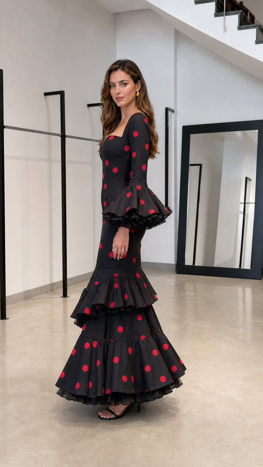 Side profile view of black and red polka dot maxi dress with ruffle sleeves