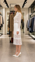 Side profile view of white lace two-piece outfit