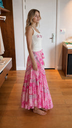 Side profile view of pink floral wrap long skirt
