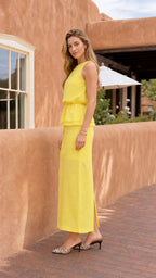 Side profile view of model in yellow maxi dress