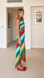 Side profile view of the striped knit midi dress with asymmetric fringed hem