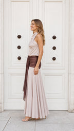 Side profile view of champagne and brown draped maxi dress