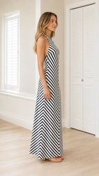 Side profile view of black and white striped maxi dress