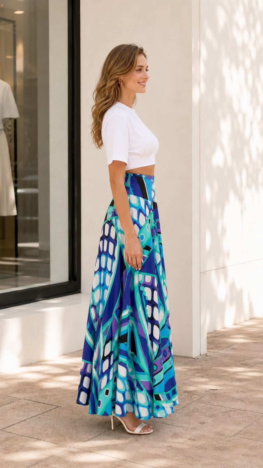 Side view of model wearing blue geometric print maxi skirt