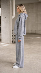 Side profile view of model in grey tracksuit set