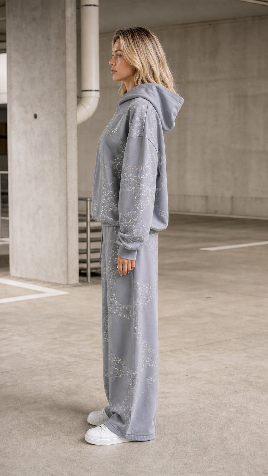Side profile view of model in grey tracksuit set