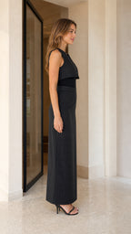 Side view of model wearing black pinstripe two-piece set