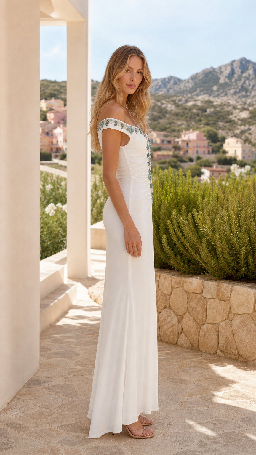 Side profile of woman in white maxi dress outdoors