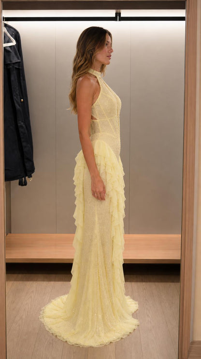 Side profile of yellow halter neck beaded ruffle maxi dress