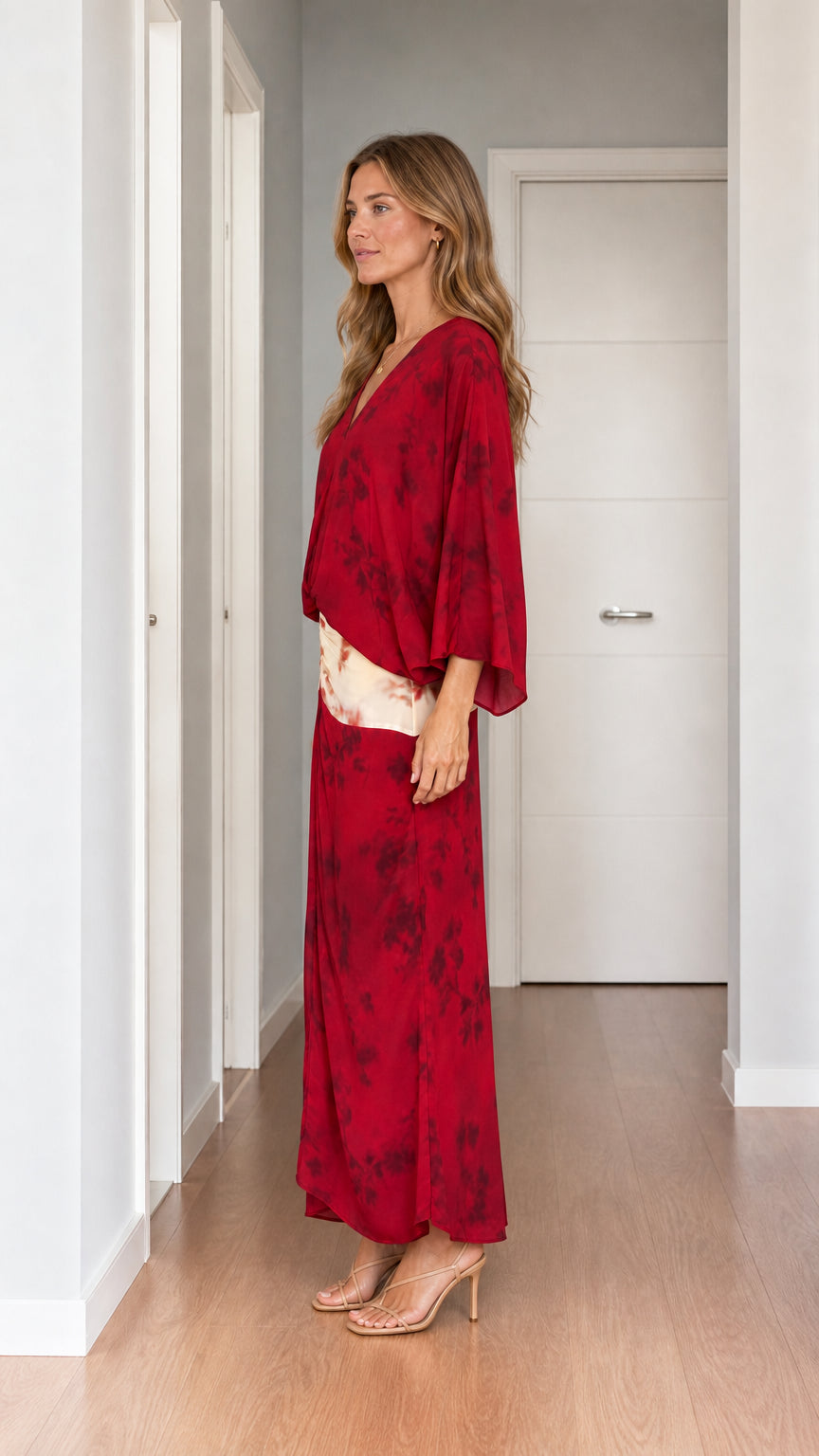 Model wearing red tie-dye two-piece set from the side profile