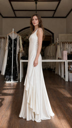 Model showcasing side profile of Ivory satin maxi dress
