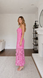 Side profile view of model in pink strapless maxi dress