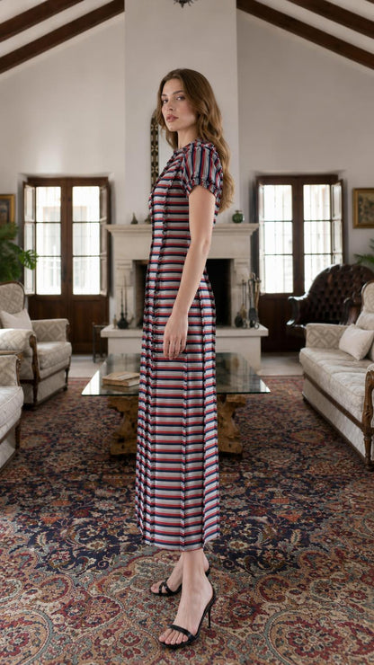Side profile view of model in multi-stripe maxi dress