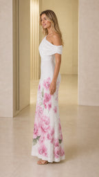 Side profile view of white one-shoulder floral gown