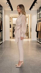 Side view of woman in beige peplum pant set with heels