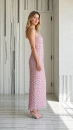 Side profile view of pink sequin halter maxi dress