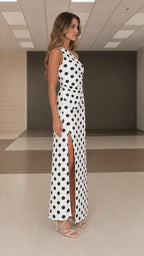 Side profile view of white polka dot one shoulder maxi dress