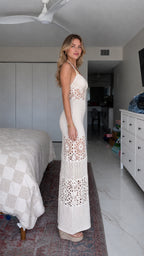 Side profile view of woman in white crochet maxi dress with wedge shoes