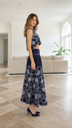 Side profile of model in navy embroidered two-piece set