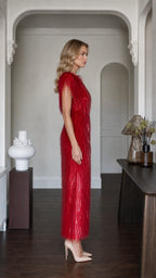Side profile view of red fringe maxi dress