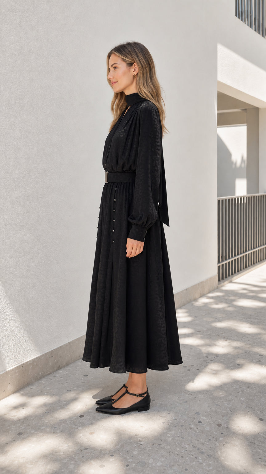 Model wearing black midi dress from the side profile