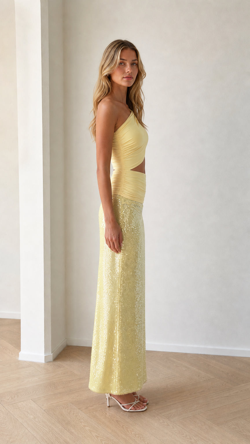 Side profile view of yellow one-shoulder cutout sequin two-piece dress