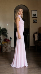 Side profile view of model wearing pink ruched mermaid dress
