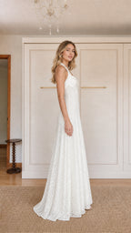 Side profile of model in White lace evening gown