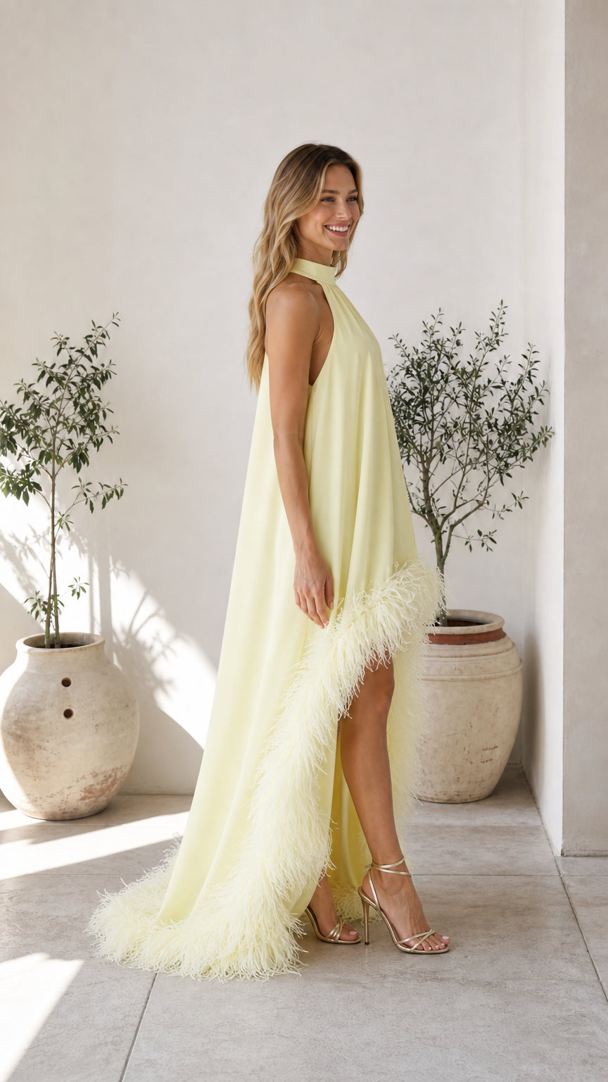 Side profile view of yellow feather hem dress