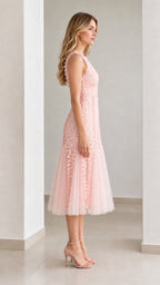 Side profile view of pink midi dress