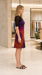 Side profile of model in multi-color ombre chevron knit dress