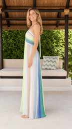 Side profile view of woman in white multi striped maxi dress