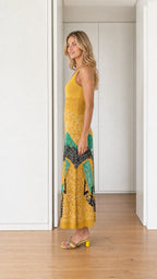 Side profile view of yellow landscape knit maxi dress