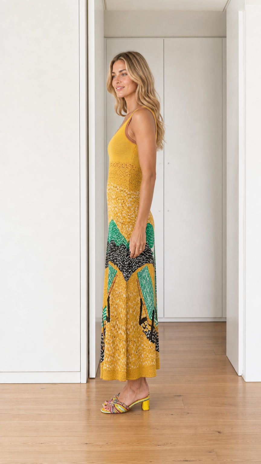 Side profile view of yellow landscape knit maxi dress