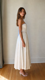 Side profile view of White strapless maxi dress