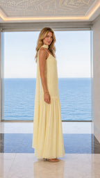 Side profile view of yellow choker maxi dress