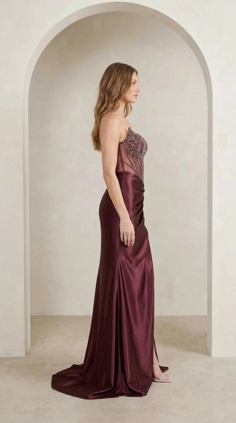 Model wearing burgundy evening gown side profile