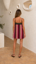 Back view of model wearing multi-pink pleated dress