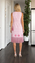 Model wearing pink gingham dress from the back