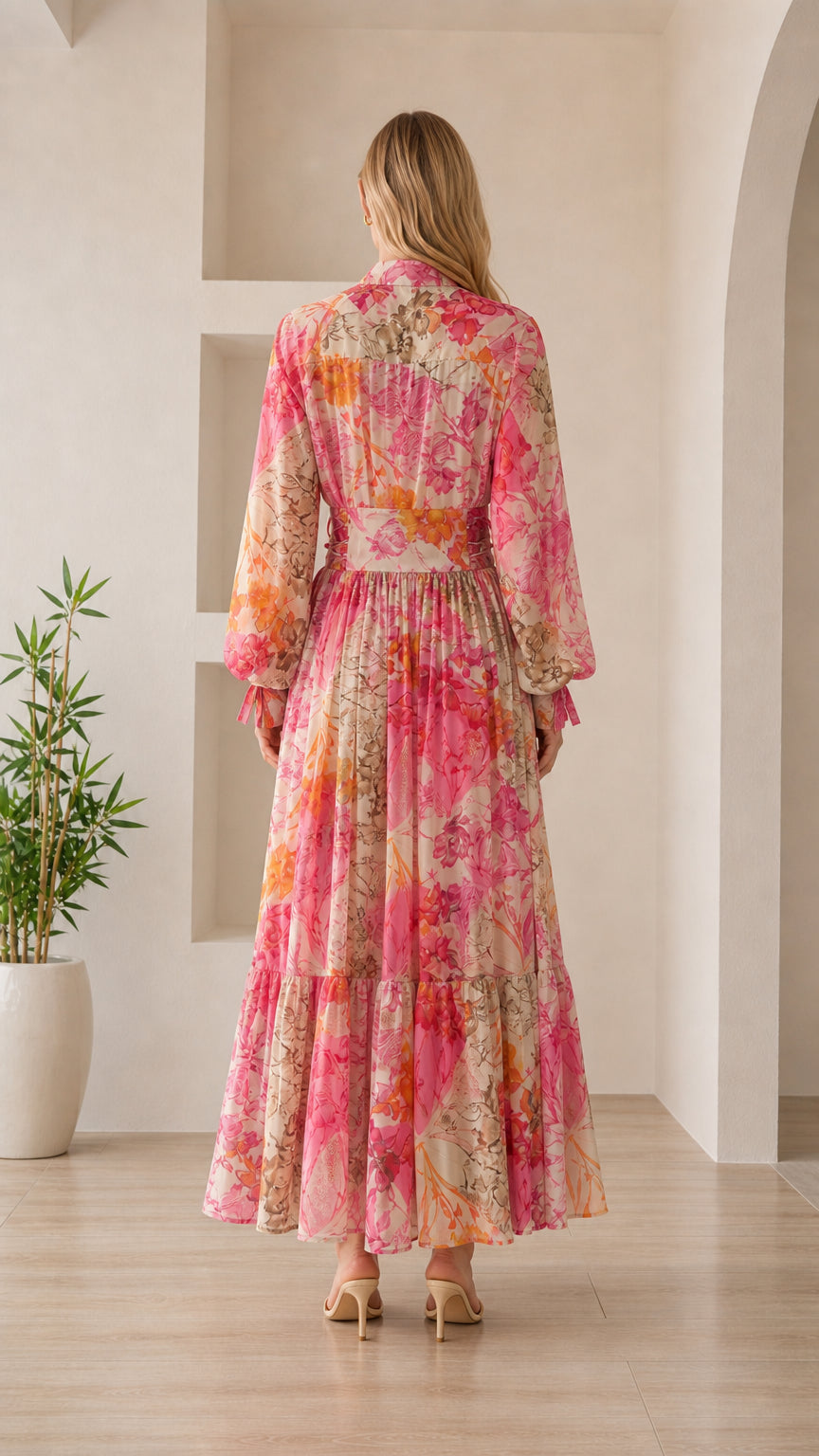 Back view of woman wearing pink floral maxi dress