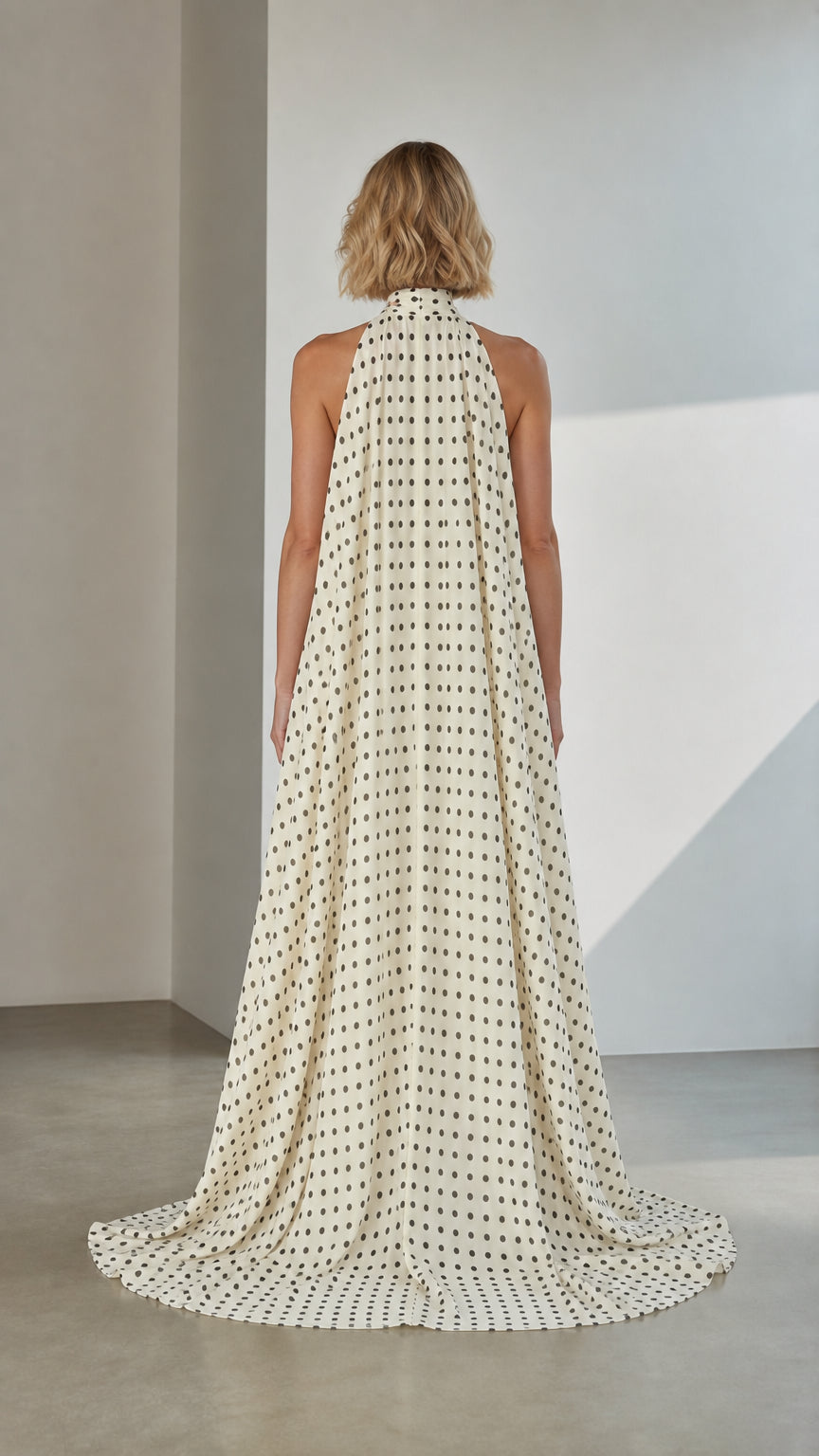 Back view of White Polka Dot Cape Evening Gown with sweeping train