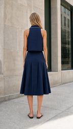 Navy sleeveless midi skirt set shown from the back