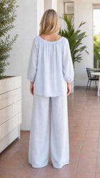 Back view of woman wearing light blue pant set