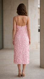 Back view of model in pink spaghetti strap midi dress